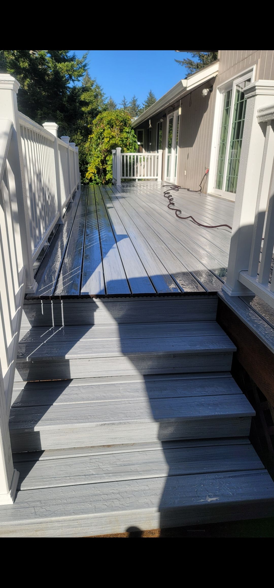 Gray composite deck with white railing on Oregon Coast home