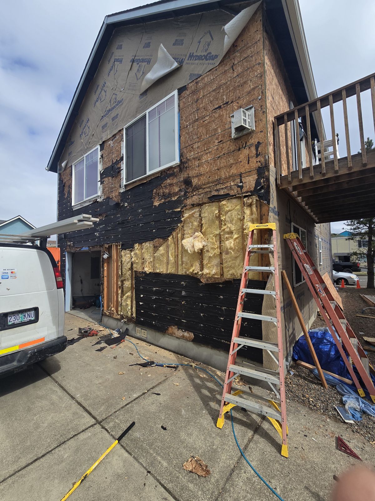 Siding stripped showing rot damage